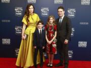 Former NASCAR driver Jeff Gordon, right, and his family from left: Ingrid Vandebosch, son Leo Benjamin and daughter Ella Sofia pose for photos before the NASCAR Hall of Fame induction ceremony for the Class of 2019, Friday, Feb. 1, 2019, in Charlotte, N.C. (AP Photo/Jason E.