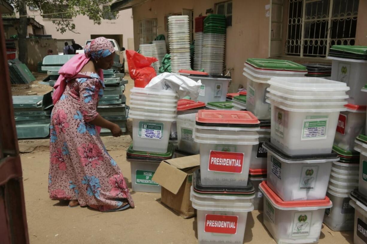 An electoral worker checks ballot boxes Sunday at the electoral commission office in Yola, Nigeria.