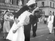 FILE - In this Aug. 14, 1945 file photo provided by the U.S. Navy, a sailor and a woman kiss in New York’s Times Square, as people celebrate the end of World War II. The ecstatic sailor shown kissing a woman in Times Square celebrating the end of World War II has died. George Mendonsa was 95. It was years after the photo was taken that Mendonsa and Greta Zimmer Friedman, a dental assistant in a nurse’s uniform, were confirmed to be the couple. (Victor Jorgensen/U.S.