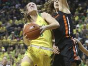 Oregon’s Sabrina Ionescu, left, goes up to shoot against Oregon State’s Mikayla Pivec during the second quarter of an NCAA college basketball game Friday, Feb. 15, 2019, in Eugene, Ore.