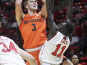 Oregon State forward Tres Tinkle (3) looks over the arms of Utah forward Both Gach (11) while shooting during the first half of an NCAA college basketball game Saturday, Feb. 2, 2019, in Salt Lake City.