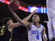 UCLA guard Jaylen Hands, right, shoots as Oregon forward Miles Norris defends during the second half of an NCAA college basketball game Saturday, Feb. 23, 2019, in Los Angeles. UCLA won 90-83. (AP Photo/Mark J.