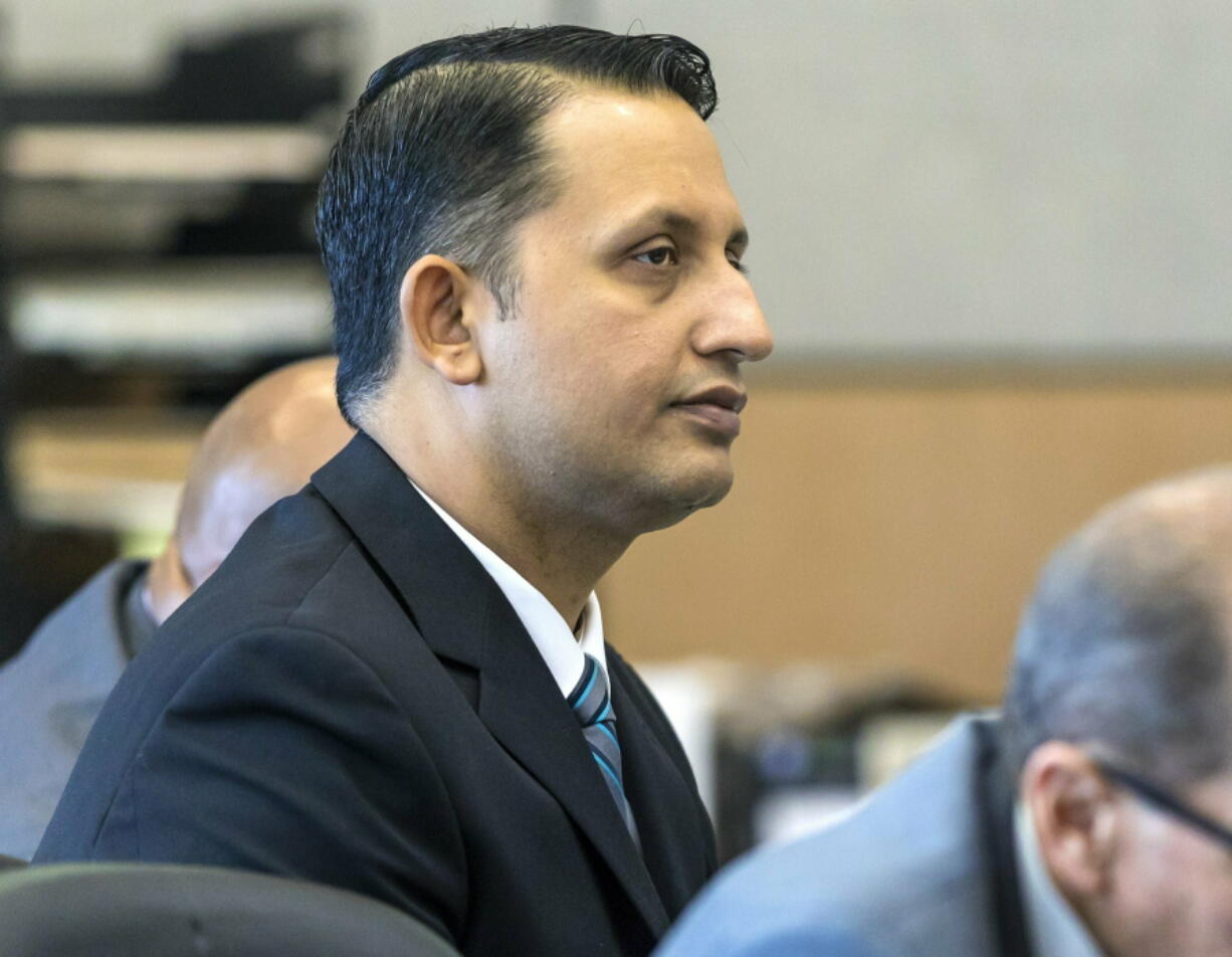 Former Palm Beach Gardens police officer Nouman Raja listens to defense attorney Scott Richardson give opening statements in Raja’s trial, Tuesday, Feb. 26, 2019, in West Palm Beach, Fla. Raja is charged with the fatal 2015 shooting of a stranded black motorist, 31-year-old Corey Jones.