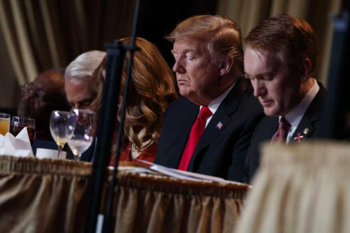 President Donald Trump prays during the National Prayer Breakfast, Thursday, Feb. 7, 2019, in Washington.