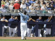 Seattle Mariners' Yusei Kikuchi tosses a baseball to fans during the first inning of a spring training baseball game against the Cincinnati Reds, Monday, Feb. 25, 2019, in Peoria, Ariz.