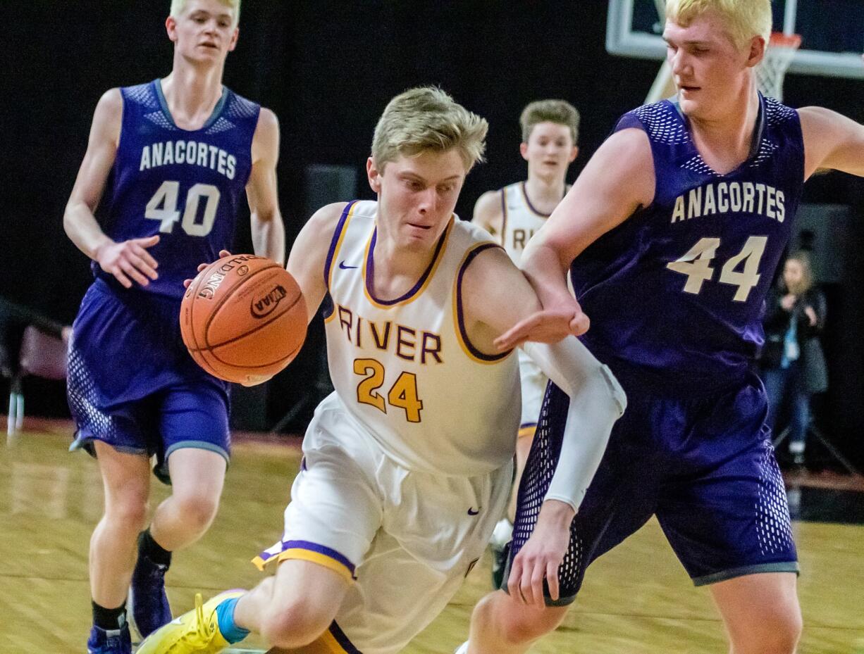 Columbia River's Jack Armstrong (24), works around Anacortes' Chase Cornett (44), toward the rim during the first round of the WIAA 1A boys state tournament on Wednesday, Feb. 27, 2019, at the Yakima Valley SunDome. The Columbia River Chieftains defeated the Anacortes Seahawks 49-37.