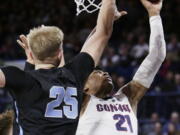 Gonzaga forward Rui Hachimura (21) shoots while defended by San Diego forward Yauhen Massalski (25) during the first half of an NCAA college basketball game in Spokane, Wash., Saturday, Feb. 2, 2019.