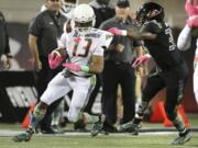 Running back Jerrion Ealy, left, gets snagged by a defender during the Under Armour All America Game in Orlando, Fla. Some drama on signing day might be drummed up around the few remaining unsigned five-star prospects. Darnell Wright, an offensive lineman from West Virginia, is expected to choose between Tennessee and Alabama. Ealy, a running back from Mississippi, will pick between Clemson and Ole Miss.