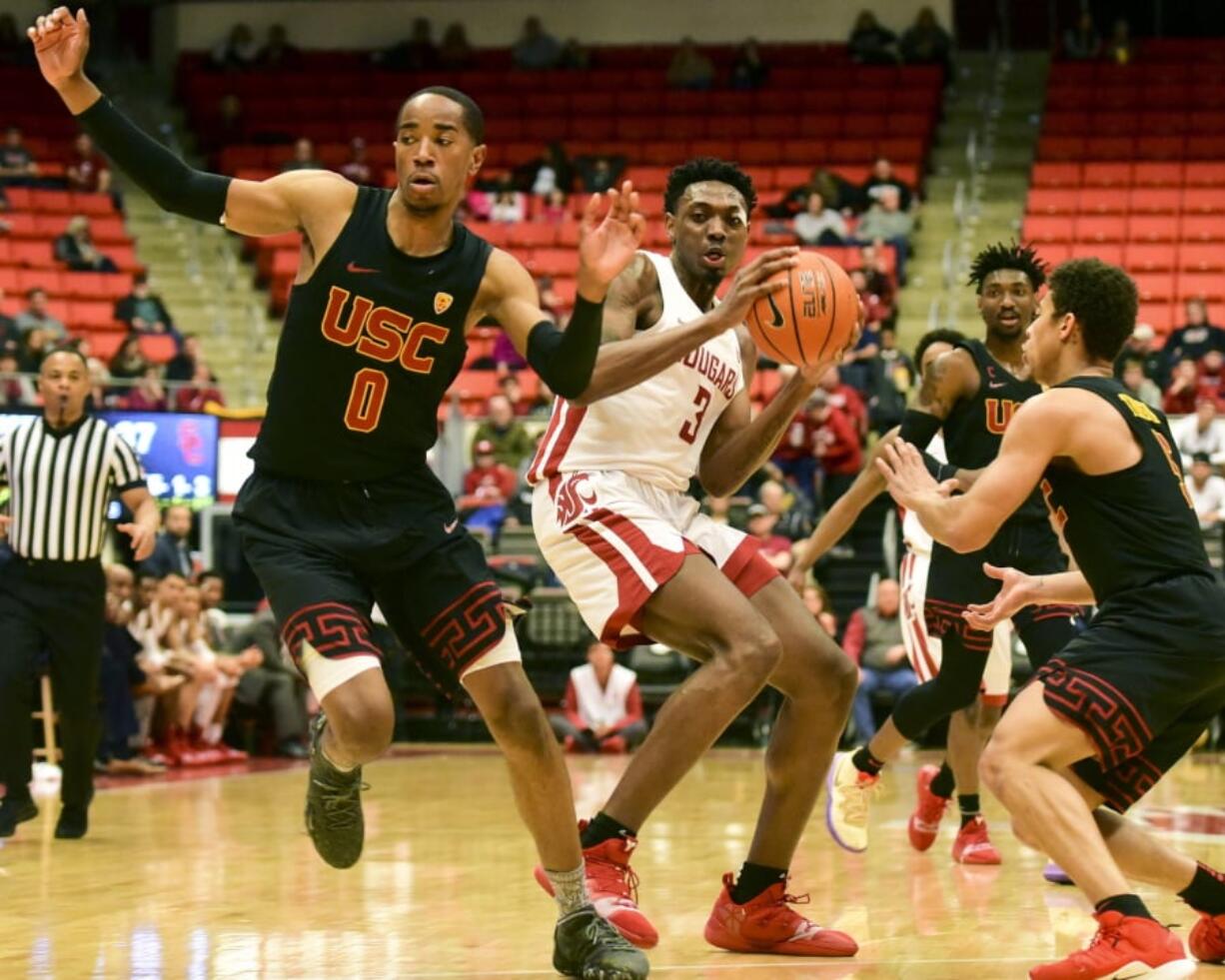 Washington State forward Robert Franks (3) picks up his dribble while defended by Southern California guard Shaqquan Aaron (0) and guard Derryck Thornton (5) during the first half of an NCAA college basketball game Saturday, Feb. 2, 2019, in Pullman, Wash.