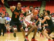 Washington State forward Robert Franks (3) picks up his dribble while defended by Southern California guard Shaqquan Aaron (0) and guard Derryck Thornton (5) during the first half of an NCAA college basketball game Saturday, Feb. 2, 2019, in Pullman, Wash.