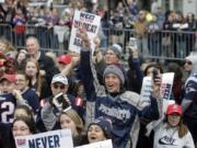 Fans wait for the New England Patriots parade to through downtown Boston, Tuesday, Feb. 5, 2019, to celebrate their win over the Los Angeles Rams in Sunday’s NFL Super Bowl 53 football game in Atlanta.