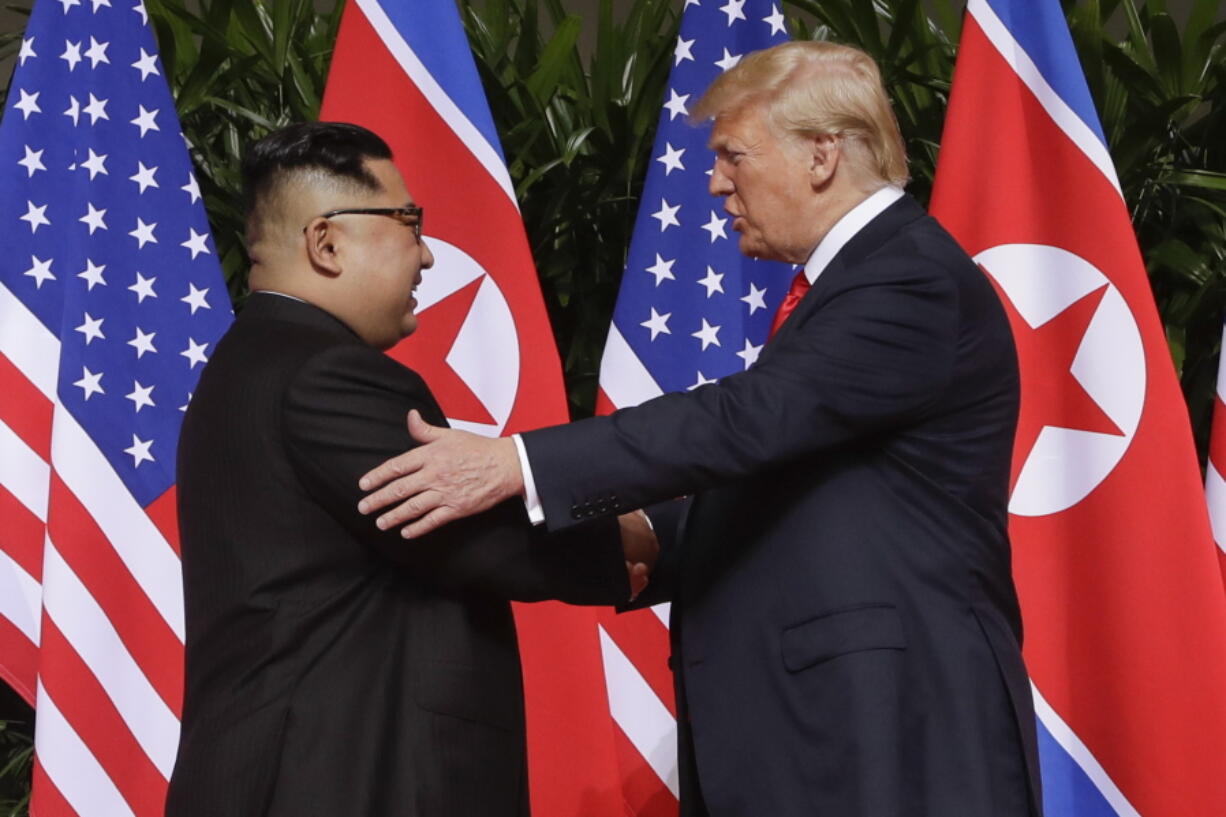 FILE - In this June 12, 2018 file photo, President Donald Trump shakes hands with North Korea leader Kim Jong Un at the Capella resort on Sentosa Island in Singapore. As he prepares to meet again North Korea’s Kim Jong Un, President Donald Trump is replaying many of the same moves, with a suspenseful buildup, make-or-break stakes and dramatic rendezvous in a far-flung locale. But the reality-star president is about to learn if the sequel can compete with the original.