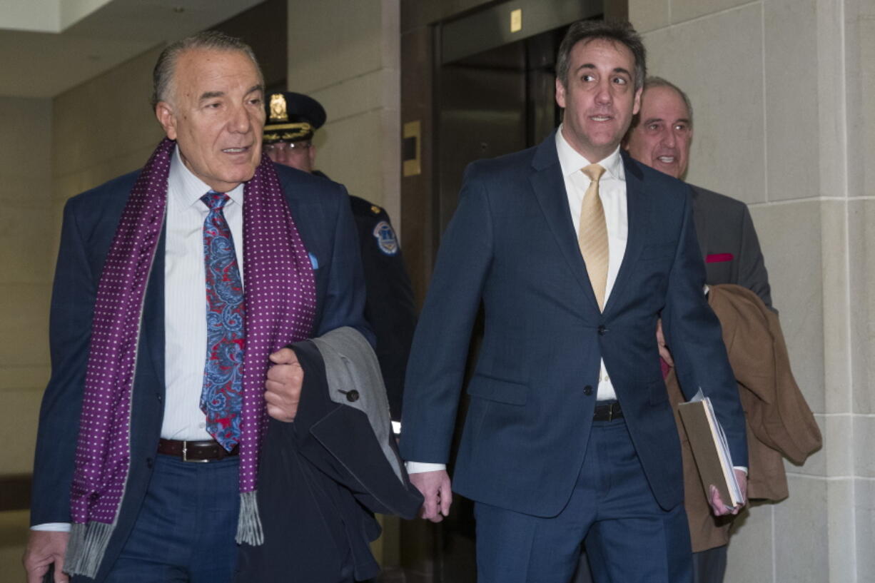 Michael Cohen, right, President Donald Trump’s former personal lawyer, arrives to testify before a closed-door hearing of the House Intelligence Committee accompanied by his lawyer, Michael Monico of Chicago, on Capitol Hill, Thursday, Feb. 28, 2019, in Washington.