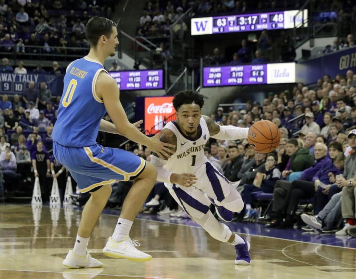 Washington guard David Crisp (1) drives around UCLA forward Alex Olesinski (0) during the second half of an NCAA college basketball game, Saturday, Feb. 2, 2019, in Seattle. Washington won 69-55. (AP Photo/Ted S.