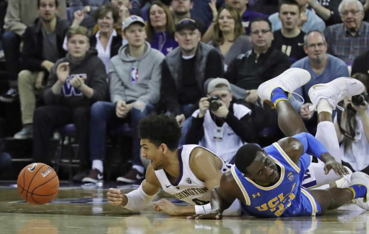 Washington guard Matisse Thybulle, left, reacts after battling with UCLA guard Prince Ali, right, for a loose ball during Saturday’s game in Seattle, which Washington won 69-55. The Huskies are 9-0 in Pac-12 play and Thybulle is regarded as one of the best defenders in college basketball. Ted S.