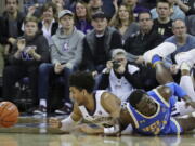 Washington guard Matisse Thybulle, left, reacts after battling with UCLA guard Prince Ali, right, for a loose ball during Saturday’s game in Seattle, which Washington won 69-55. The Huskies are 9-0 in Pac-12 play and Thybulle is regarded as one of the best defenders in college basketball. Ted S.