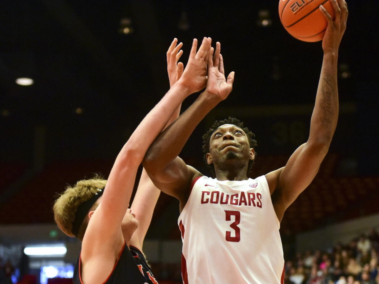 Washington State forward Robert Franks (3) shoots as Utah center Jayce Johnson defends during the first half of an NCAA college basketball game Saturday, Feb. 23, 2019, in Pullman, Wash.