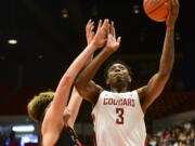 Washington State forward Robert Franks (3) shoots as Utah center Jayce Johnson defends during the first half of an NCAA college basketball game Saturday, Feb. 23, 2019, in Pullman, Wash.