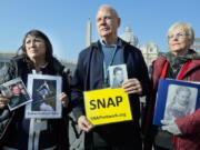 Survivors Network of those Abused by Priests members, from left, Esther Hatfield Miller of Los Angeles, SNAP President Tim Lennon of Tucson, Ariz., and Carol Midboe of Austin, Texas, meet with the media Wednesday in St. Peter’s Square at the Vatican.