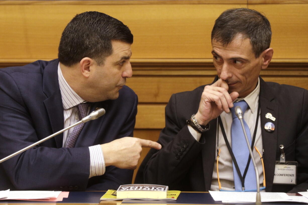 Survivor of sex abuse Francesco Zanardi, right, listens to Mark Rozzi, Democratic member of the Pennsylvania House of Representatives, during a press conference at the Italian Lower Chamber press hall in Rome, Thursday, Feb. 21, 2019. Pope Francis opened a landmark sex abuse prevention summit Thursday by warning senior Catholic figures that the faithful are demanding concrete action against predator priests and not just words of condemnation.