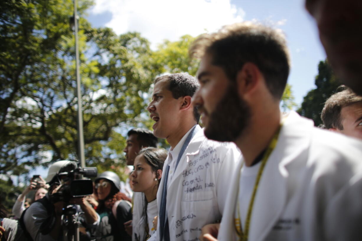 Opposition National Assembly President Juan Guaido, who declared himself interim president of Venezuela, takes part in a walk out against President Nicolas Maduro, in Caracas, Venezuela, Wednesday, Jan. 30, 2019. Venezuelans are exiting their homes and workplaces in a walkout organized by the opposition to demand that Maduro leave power.