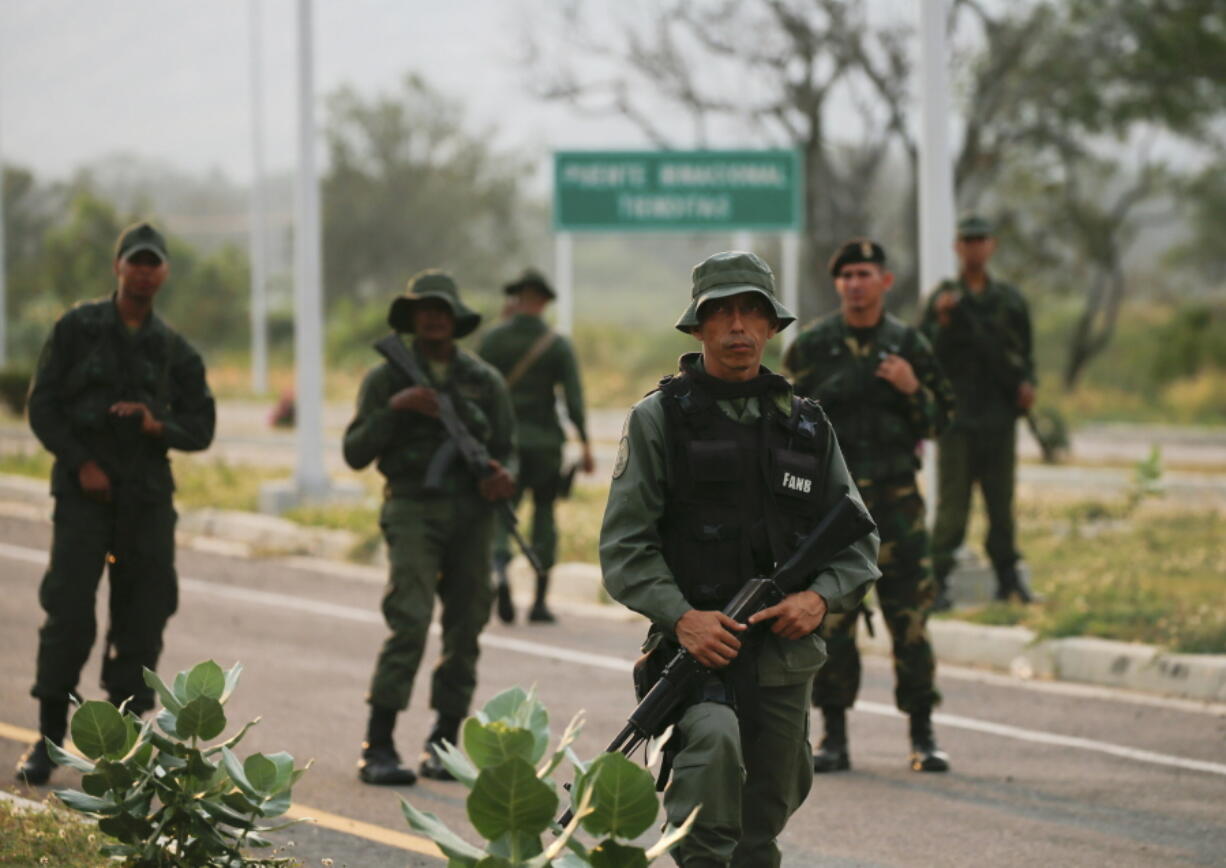 Members of the Venezuelan army and National Guard block the main access to the Tienditas International Bridge, which links Colombia and Venezuela, on Thursday near Urena, Venezuela.