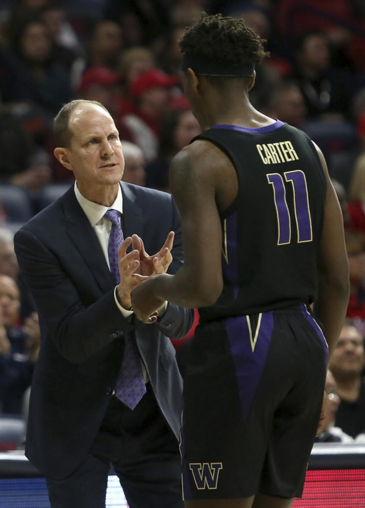 Washington head coach Mike Hopkins, left, talks with guard David Crisp (1) in the first half of an NCAA college basketball game against Arizona in Tucson, Ariz., Thursday, Feb. 7, 2019.