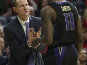 Washington head coach Mike Hopkins, left, talks with guard David Crisp (1) in the first half of an NCAA college basketball game against Arizona in Tucson, Ariz., Thursday, Feb. 7, 2019.