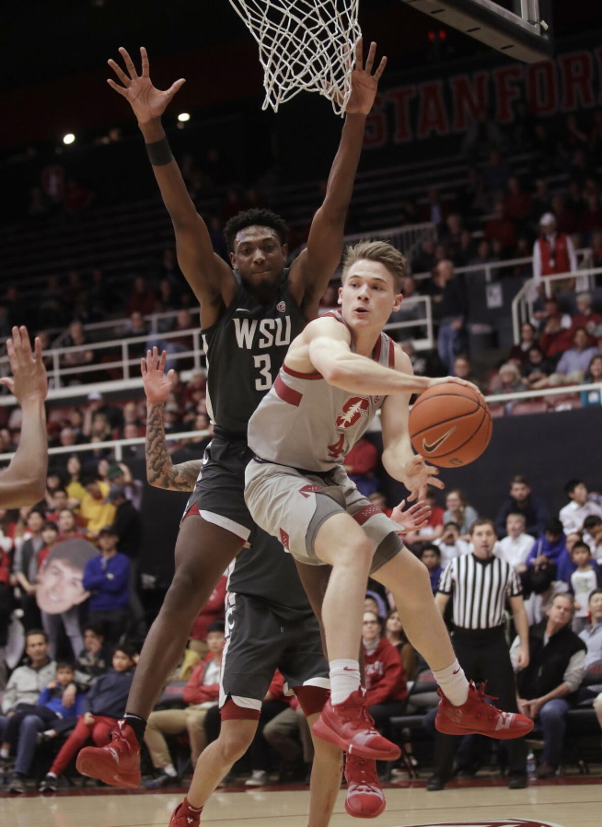 Stanford guard Isaac White, right, passes the ball in front of Washington State forward Robert Franks during the first half of an NCAA college basketball game in Stanford, Calif., Thursday, Feb. 28, 2019.