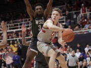 Stanford guard Isaac White, right, passes the ball in front of Washington State forward Robert Franks during the first half of an NCAA college basketball game in Stanford, Calif., Thursday, Feb. 28, 2019.