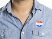 A man wears an "I Voted" sticker.