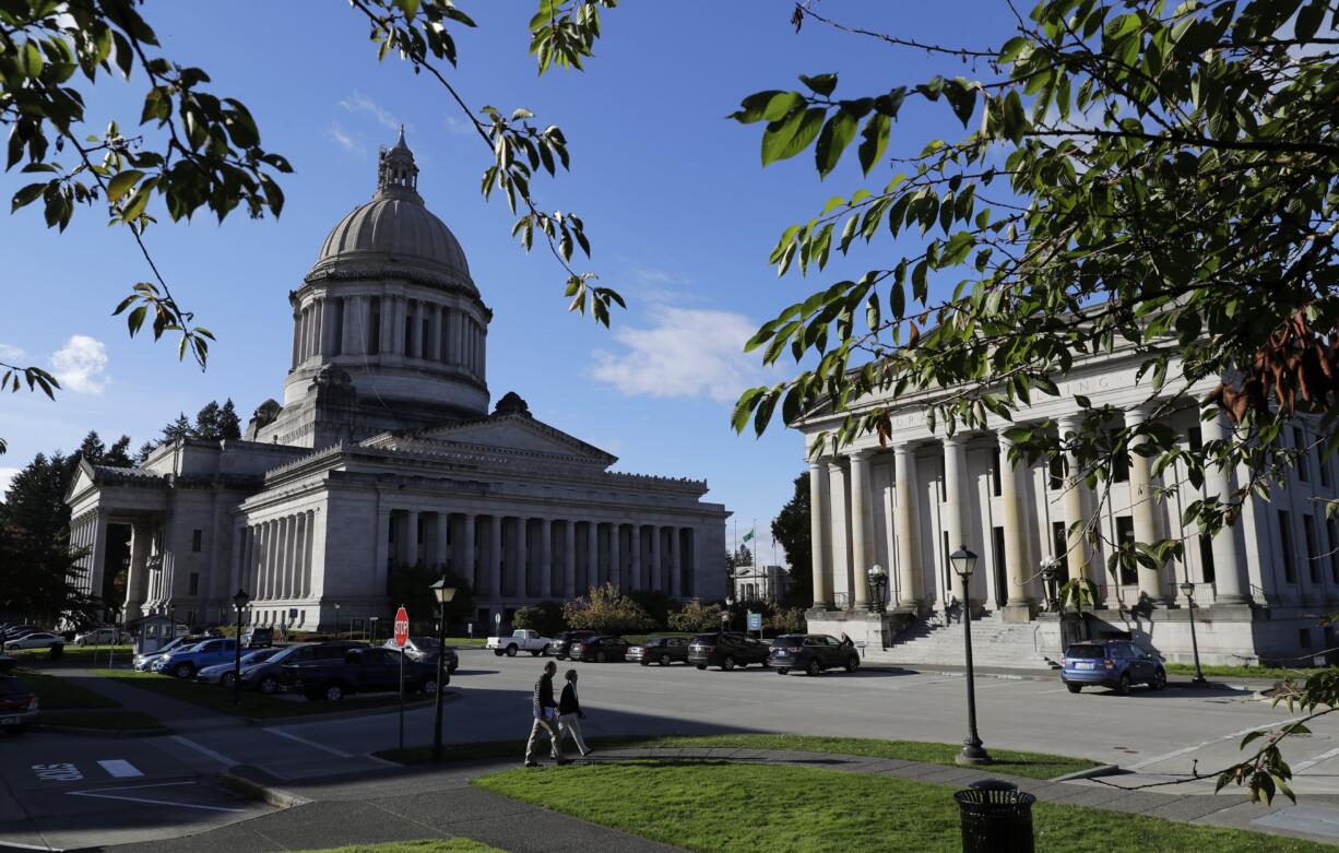 The afternoon sun illuminates the Legislative Building, left, and the Insurance Building, right, at the Capitol in Olympia in October.