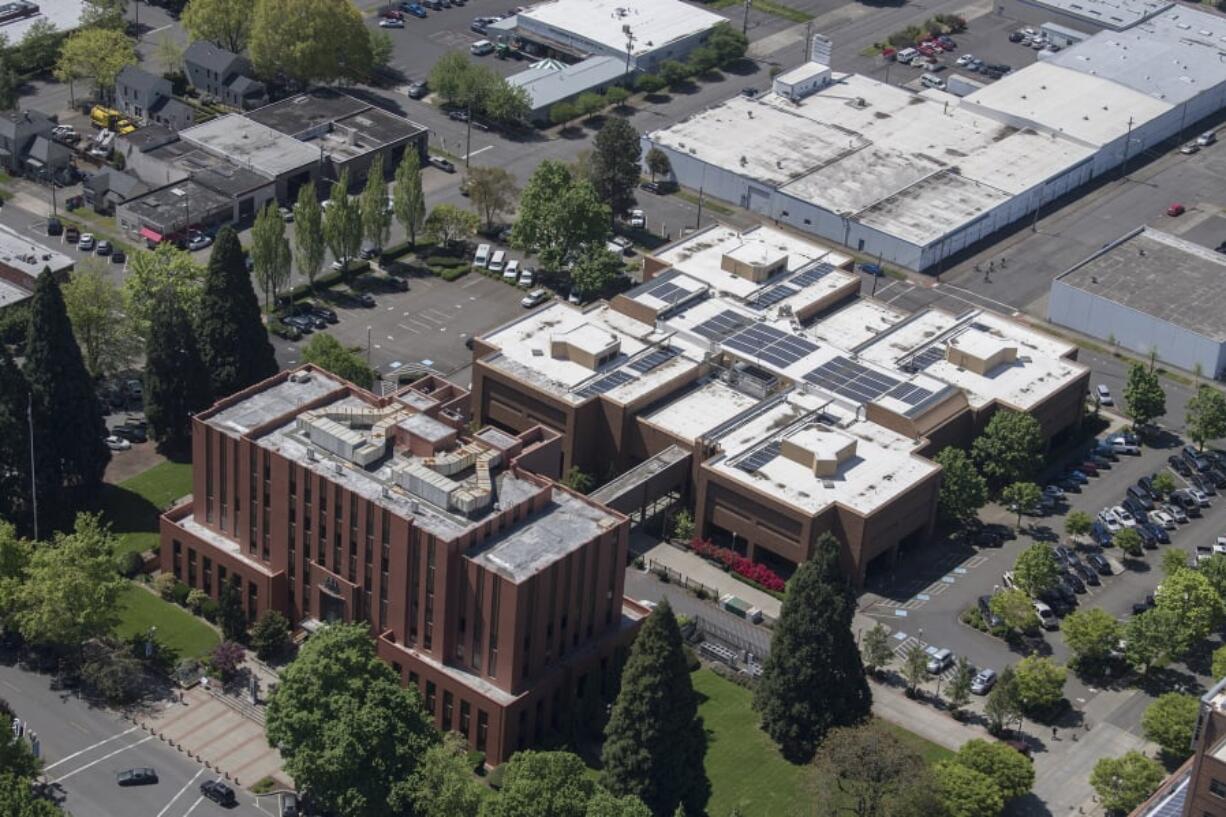 The Clark County Courthouse, front, and Clark County Jail in downtown Vancouver are pictured in May 2019.