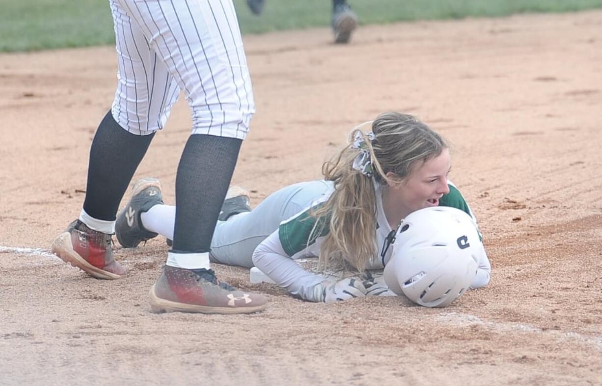 Woodland's Gwen Elkinton reacts after sliding in safely to third base with a triple against Camas on Monday at Camas High.