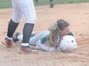 Woodland's Gwen Elkinton reacts after sliding in safely to third base with a triple against Camas on Monday at Camas High.