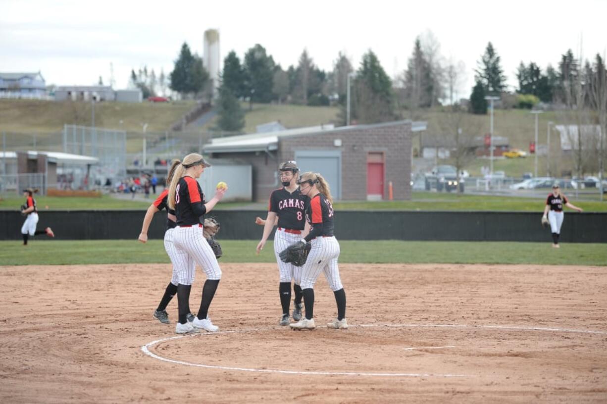 Camas players gather after an out against Woodland on March 11. The Papermakers have finished fourth place at the Class 4A state tournament in three of the past four seasons.