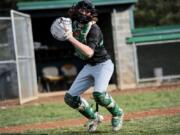 Evergreen senior catcher Blake Whitehead, the glue guy on a small roster, winds up to throw a ball to coach Chad Burchett at Evergreen High School.