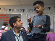 Teacher Adam Aguilera helps fourth-grader Kaler Mathews with a math exercise in November at Pioneer Elementary School in Vancouver.