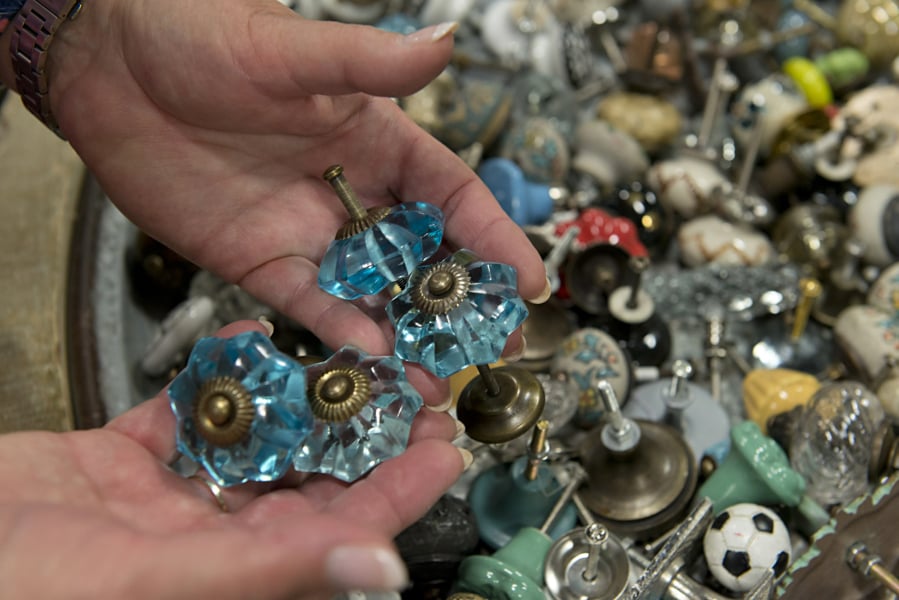 NW Largest Garage Sale and Vintage Sale at the Clark Co. Event Center. Amy Colville, of Portland, shops for drawer pulls.