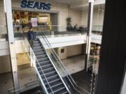 A shopper walks down the stairs near the former Sears location at the Vancouver Mall in November. The space will apparently be split into a Hobby Lobby and a Round1 amusement center.
