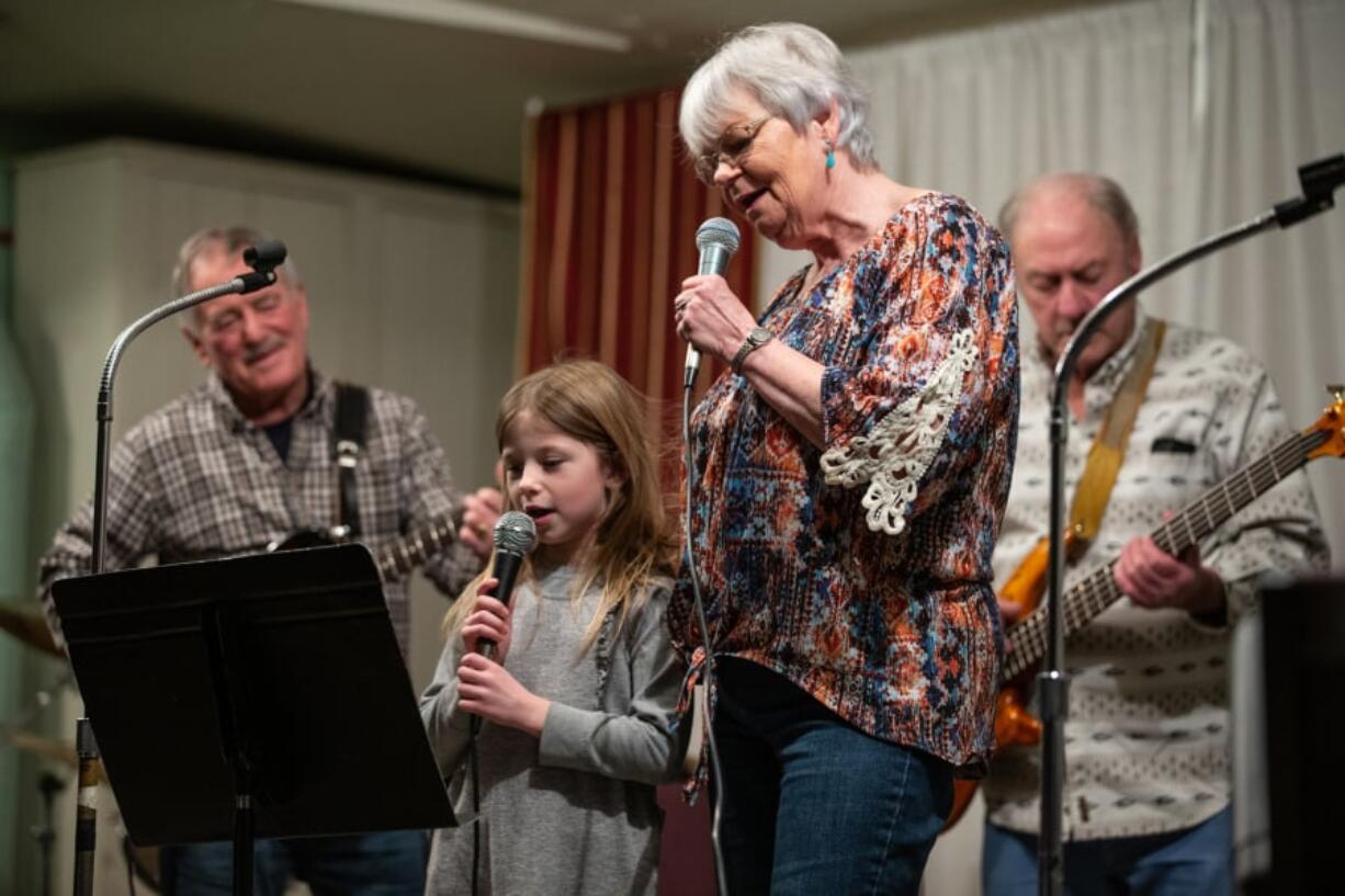 Six-year-old Megan Wilder helps her grandmother, Eilene Laing, sing “You Are My Sunshine” during the biweekly gathering of the Columbia River Old Time Strings at the Minnehaha Grange. Accompanying them are Jerry Jacobs on guitar and Ron Coon on bass. Randy L.