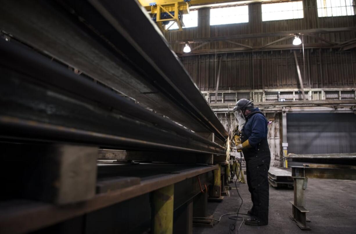 Mechanic Adam Dietrich preps a part for fit in a local dam project at Vigor in Vancouver’s Columbia Business Park.