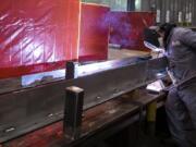 Mechanic Jeremy O’Hearn welds a part for a local dam project at a Vigor facility in Vancouver’s Columbia Business Park.