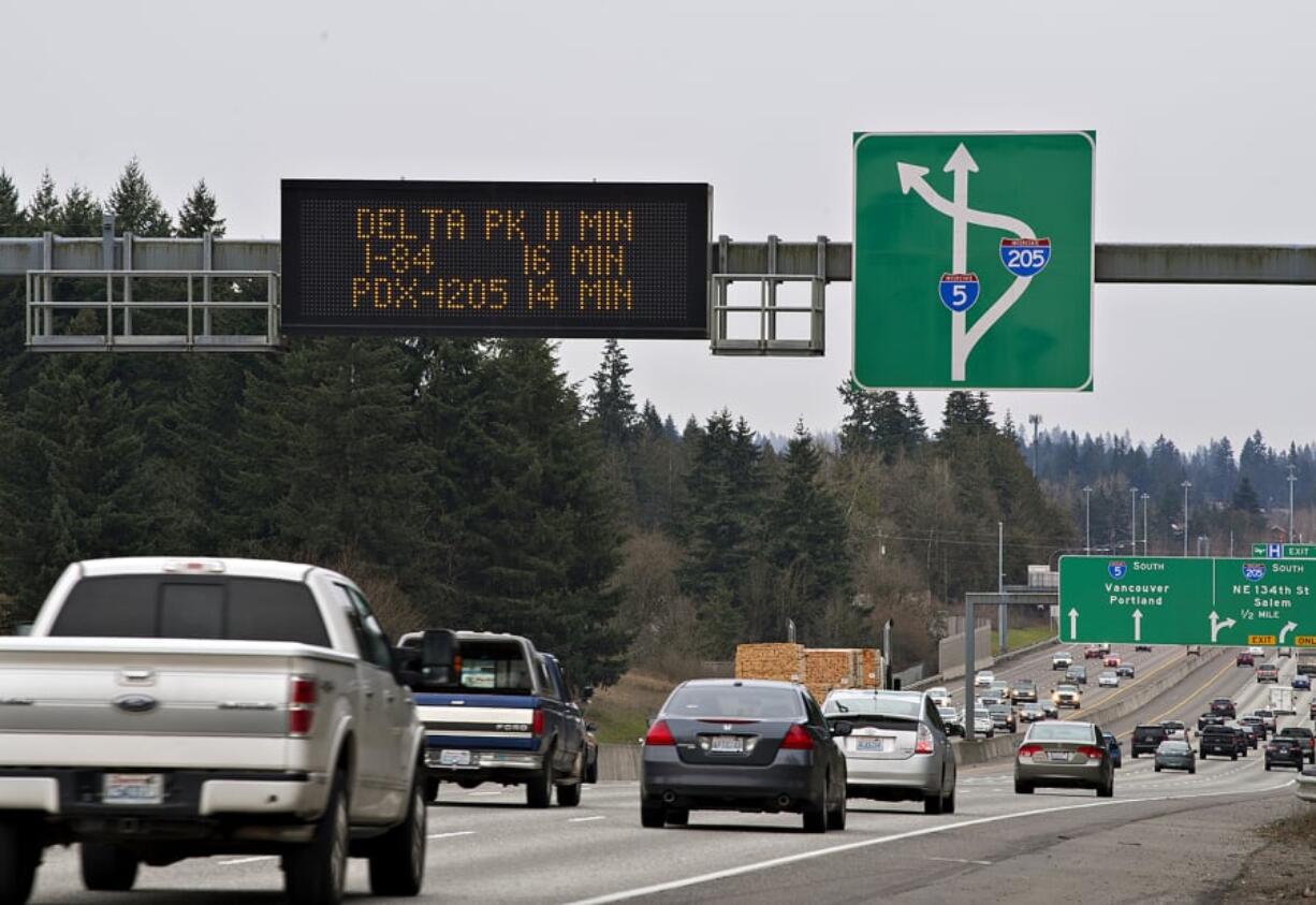 A travel-time sign gives traffic in the southbound lanes of Interstate 5 just south of the Clark County Event Center at the Fairgrounds an estimate for traffic down the road. Signs like these use roadway sensors and radar devices to measure the speed and density of passing traffic, and a computer program uses the information to estimate travel times between two points.