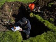 Antonio Delgado, an environmental health specialist with Clark County, tests the soil where a septic system was proposed in 2019 in Ridgefield.