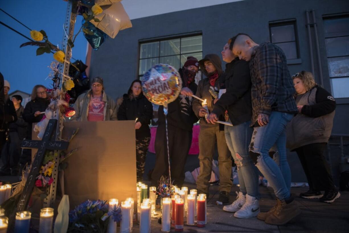 Friends and loved ones of Michael Eugene Pierce gather for an emotional candlelight vigil in his memory Friday evening in downtown Vancouver. About 30 people, many of them homeless, shared memories and jokes about the man Vancouver police officers shot and killed Thursday night.