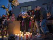 Friends and loved ones of Michael Eugene Pierce gather for an emotional candlelight vigil in his memory Friday evening in downtown Vancouver. About 30 people, many of them homeless, shared memories and jokes about the man Vancouver police officers shot and killed Thursday night.