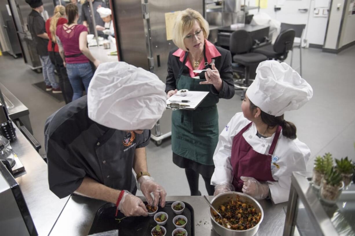 Michael Gonser, 18, Washougal Superintendent Mary Templeton and Joselyn Guajardo talk about a dish that Guajardo prepared for the Washougal Future Chefs competition at Washougal High School. Templeton’s first years as superintendent started late due to teacher strikes, which followed a rough patch between Washougal’s administration and teachers union in the year prior. She taking over, she has been a big hit in the district by improving communication and embracing her role as face of the district.