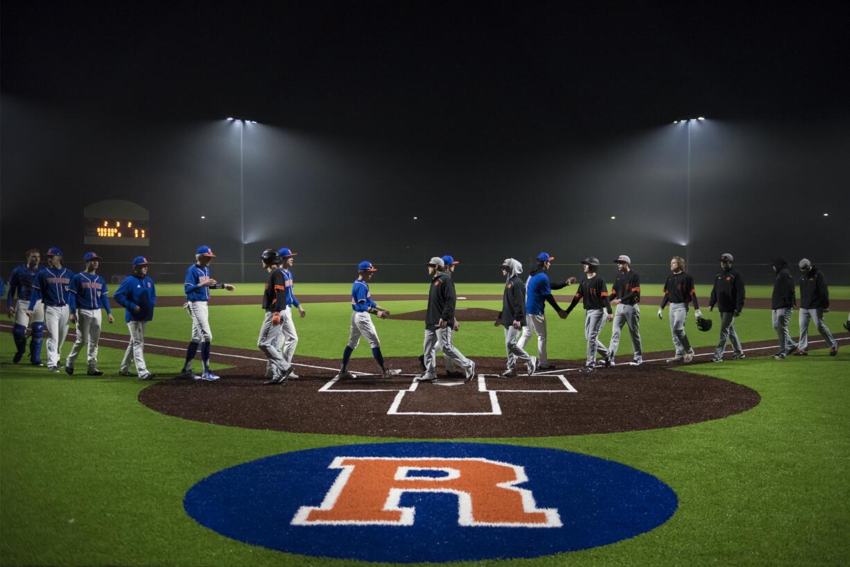 Ridgefield and Kalama shake hands following the first game at the new Ridgefield Outdoor Recreation Complex Friday, March 8, 2019.