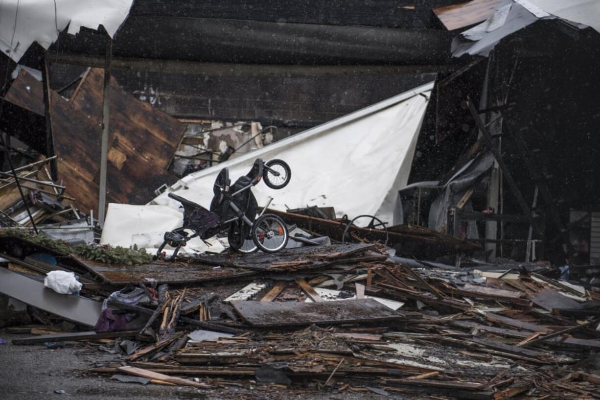 A stroller sits among the ruins at the Holly Park Shopping Center in Hazel Dell, home to a dozen businesses before the Jan. 19 fire. Less-damaged parts of the strip mall are projected to reopen in six to eight months.